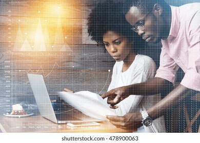 Business And Career Concept. Double Exposure. Team Work: Dark-skinned Man In Pink Shirt Explaining Business Strategy To Female Manager With Afro Hairstyle, Using Laptop During Meeting At Hotel Lobby