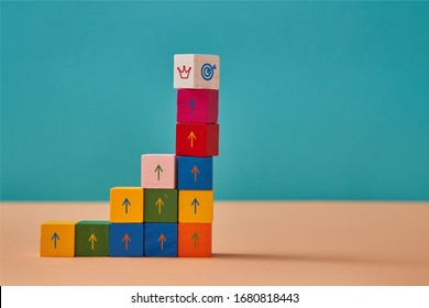 Business And Career Development. Goal Achievement. Colorful Blocks Stack With Marketing Signs And Crown, Target On Top