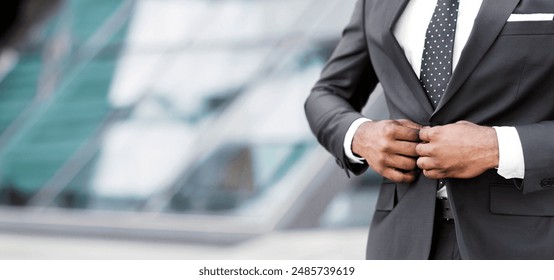 Business Career. Unrecognizable African American Businessman Buttoning Up Suit Jacket Outdoor In City. Cropped, Copy Space - Powered by Shutterstock