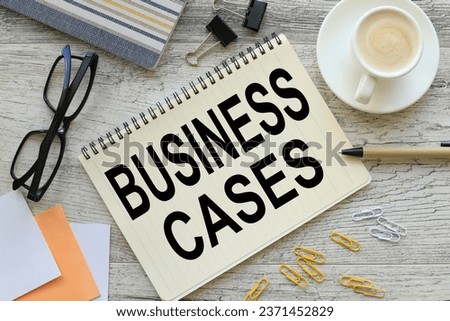 BUSINESS CASES notepad with text. a cup of coffee