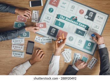 Business Challenge Board Game And Players At Table Rolling Dices, Hands Close Up, Top View