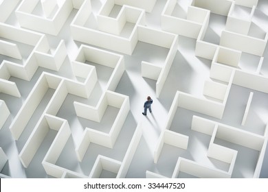 Business Challenge. A Businessman Navigating Through A Maze. Top View