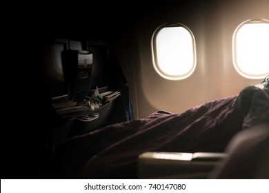 Business Class Cabin Interior, A Passenger Is Sleeping Under A Blanket In Business Class Cabin.