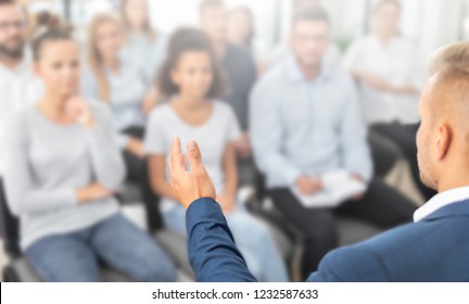 Business coach. Team leader teaches employees at a business meeting in a conference room. - Shutterstock ID 1232587633