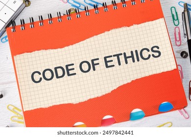 Business and code of ethics concept. Copy space. Concept words Code of ethics on a piece of paper on a notebook