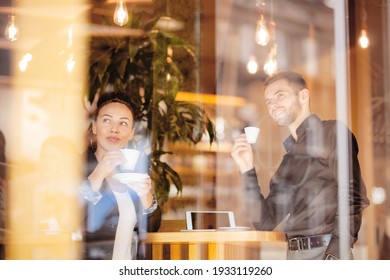 Business Coleagues Having A Coffee At A Cafe Bar