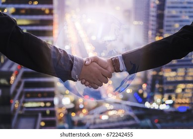 Business Collaboration, Businessman Shake Hands With 3D Global And Blur Background Night City Town.