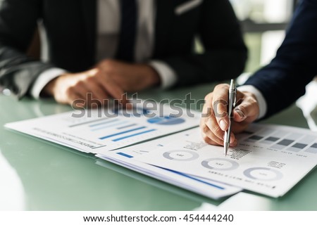 Business Colleague Discussing Paperwork Graphs Concept