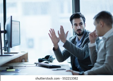 Business IT colleague explaining project details in office
