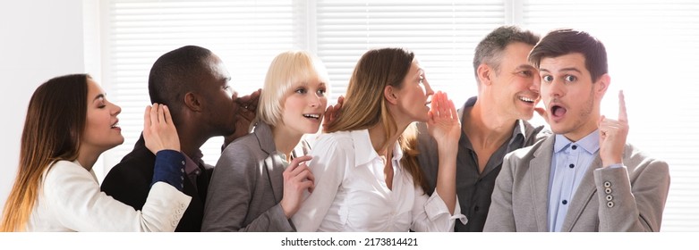 Business Colleague Whispering Secret Gossip To An Amazed Shocked Man With Wide Open Mouth - Powered by Shutterstock