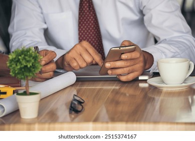 Business colleague working together using smartphone searching website and blogs for business news in conference room. Asian young man wear suit and tide formal dress waiting meeting. Business concept - Powered by Shutterstock