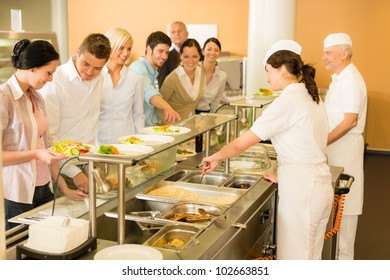 Business Colleagues In Cafeteria Cook Serve Fresh Healthy Food Meals