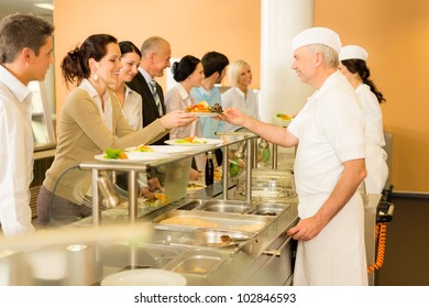 Business Colleagues In Cafeteria Cook Serve Fresh Healthy Food Meals