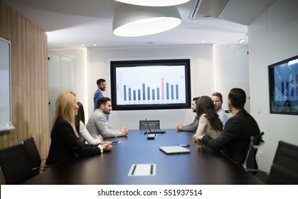 Business Colleagues In Conference Meeting Room During Presentation