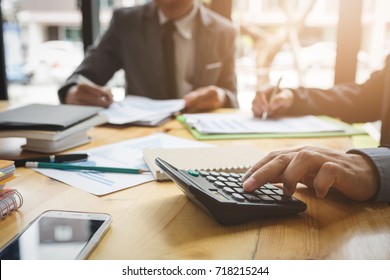 Business colleagues are discussing in the conference room. With documentation about the loan to buy real estate And materials for use in private enterprises. - Shutterstock ID 718215244