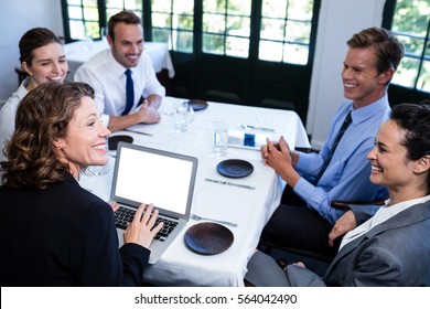 Business Colleagues Discussing During A Lunch Meeting In Restaurant