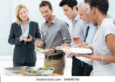 Business Colleagues Eating Meal Together In Restaurant - Powered by Shutterstock