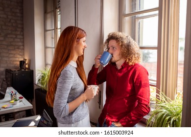 Business Colleagues Having Fun At The Office During A Coffee Break; Freelancers Woking Together In Coworking Space Taking A Coffee Break