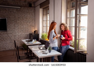 Business Colleagues Having Fun At The Office During A Coffee Break; Freelancers Woking Together In Coworking Space Taking A Coffee Break