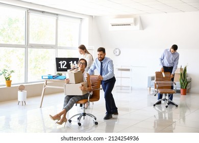 Business colleagues having fun while packing things in office on moving day - Powered by Shutterstock