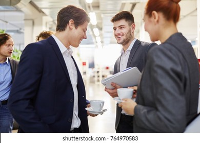 Business Colleagues Making Small Talk In Their Break