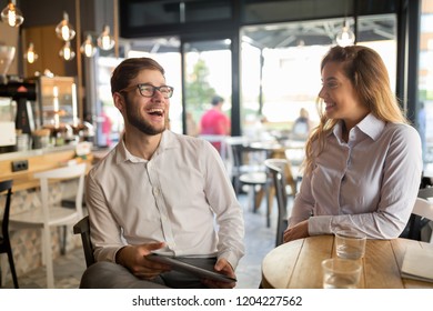 Business Colleagues Meeting At Cafe