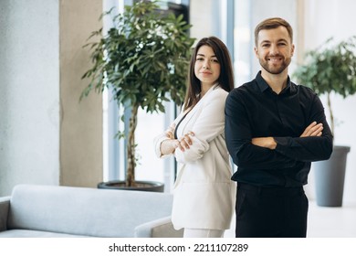 Business Colleagues Standing Side By Side At The Office