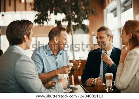 Business colleagues talking during a coffee break at a cafe