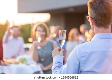 Business Colleagues Toasting Wineglasses During Rooftop Success Party