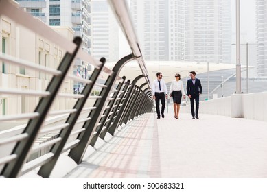 Business Colleagues Walking And Talking At Dubai Marina.