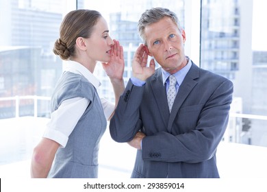 Business Colleagues Whispering In The Office