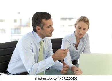 Business colleagues working on laptop 