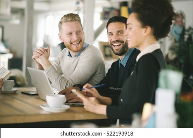 Business colleagues working together in cafe - Shutterstock ID 522193918