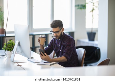 business, communication and people concept - happy businessman with laptop computer calling on desk phone at office