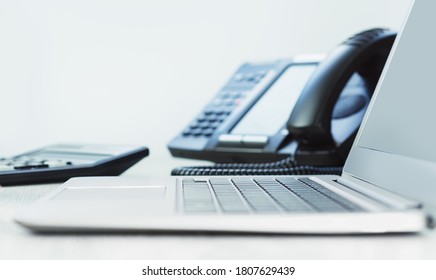 Business And Communications. Laptop And Voip Phone In The Office, Close Up Of Hand. Finance Graphs. Laptop On Desk. IP Telephony, Cold Calling. Audit Or Accounting. Business Induction Banner