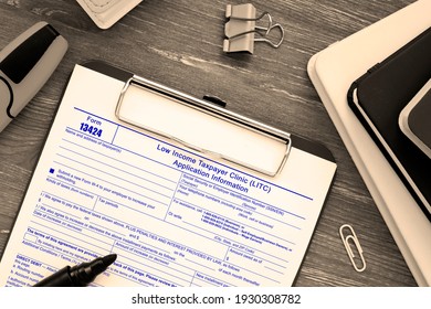 Business concept about Form 13424 Low Income Taxpayer Clinic (LITC) Application Information with inscription on the piece of paper. - Shutterstock ID 1930308782