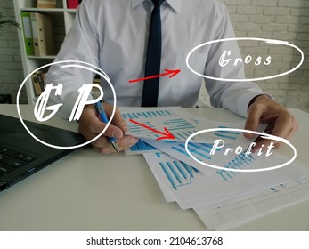 Business concept about GP Gross Profit with handwritten note.Senior Man Checking A Document on background.