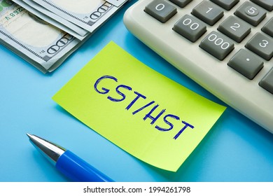 Business concept about GST HST Goods Services Tax Harmonized Sales Tax with inscription on the sheet. 

