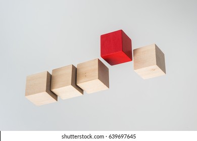 Business concept - Abstract geometric real floating wooden cube on grey background and it's not 3D render. the symbol of leadership, teamwork and growth.