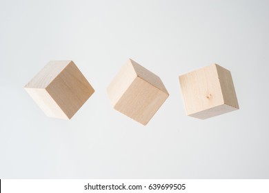 Business concept - Abstract geometric real floating wooden cube on grey background and it's not 3D render.