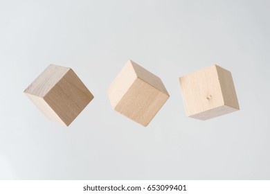 Business Concept - Abstract Geometric Real Floating Wooden Cube On Grey Background And It's Not 3D Render.