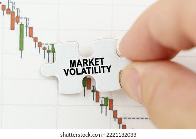 Business concept. Against the background of the quotes chart, a puzzle with the inscription - Market Volatility