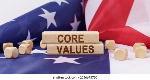 Business Concept. The American Flag Has Wooden Cubes And Plaques That Say - CORE VALUES