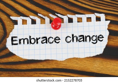 Business concept. Attached to the board is an announcement with the inscription - Embrace change