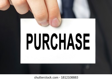 Business concept. Businessman shows a card with the text - PURCHASE - Shutterstock ID 1812108883