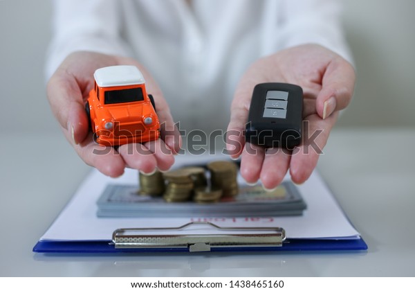 Business concept, car\
insurance, sell and buy car, car financing, car key for Vehicle\
Sales Agreement.