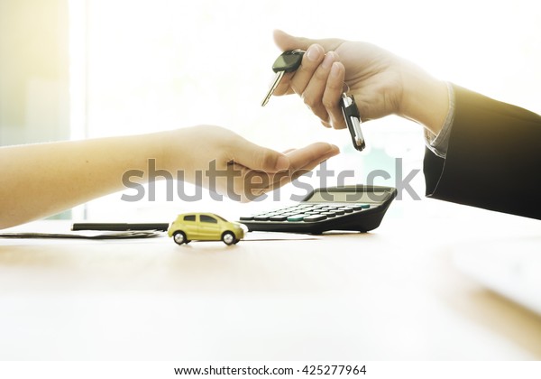 Business concept, car\
insurance, sell and buy car, car financing, car key for Vehicle\
Sales Agreement