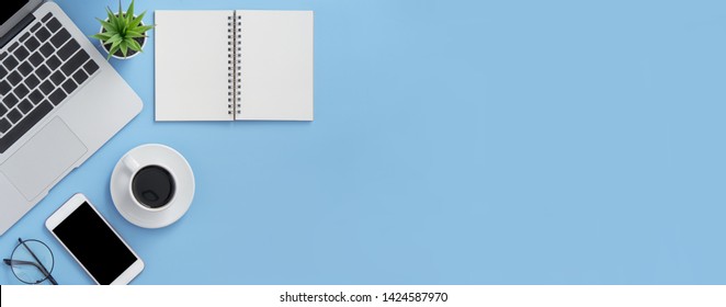 Business Concept. Clean Bright Light Blue Office Table Desk, Minimal Style With Laptop Coffee And Smart Phone, Copy Space, Top View, Flat Lay, Mockup