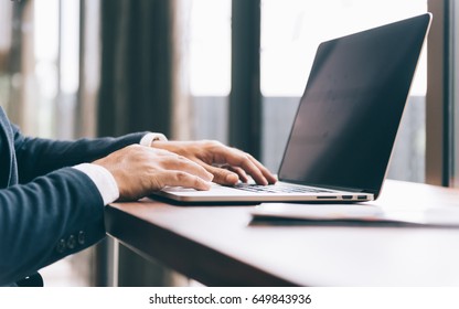 business concept , close up of hand businessman use laptop on office space