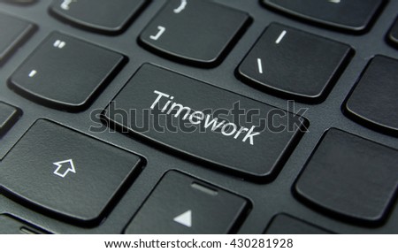 Business Concept: Close-up the Timework button on the keyboard and have Black color button isolate black keyboard